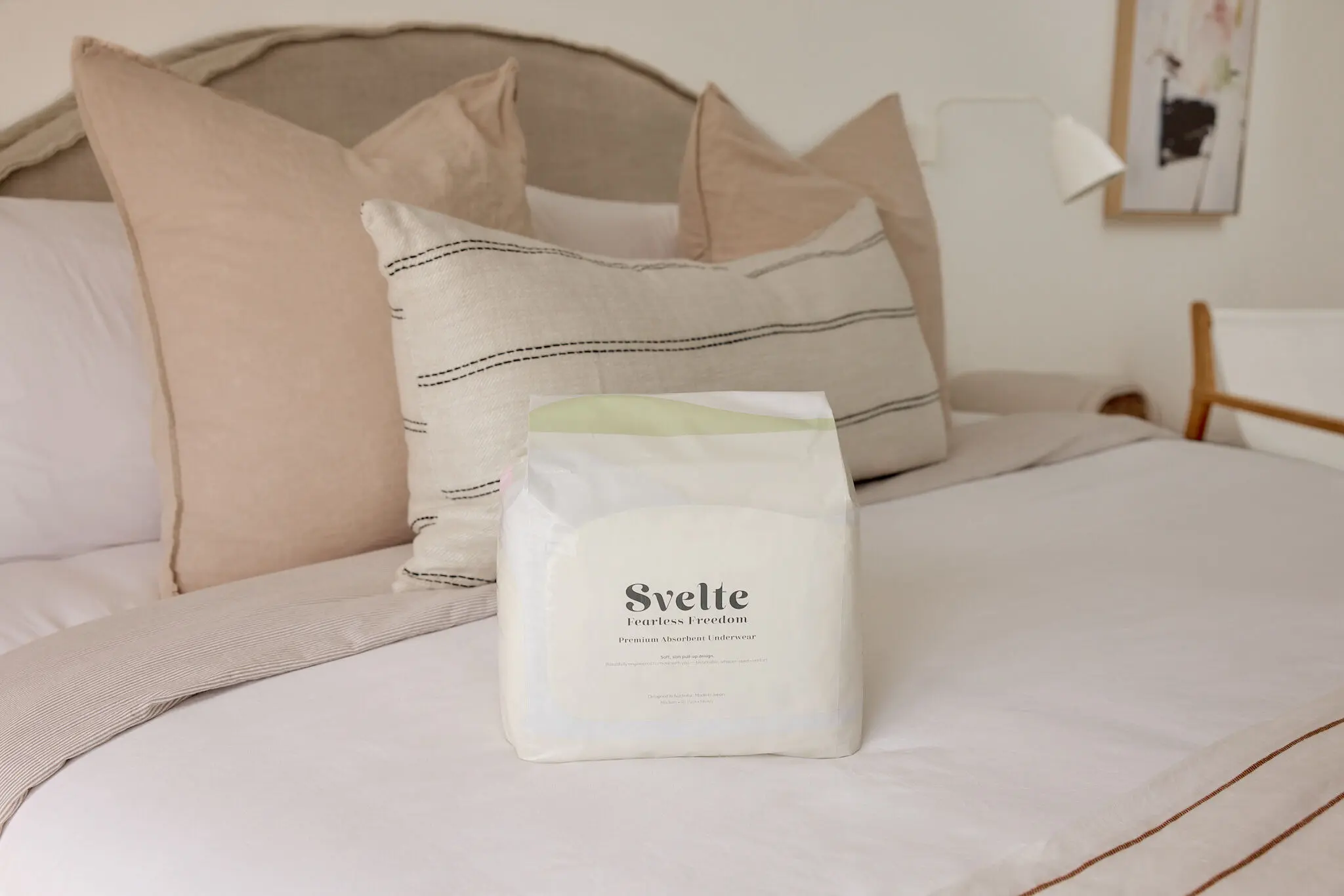 Svelte continence underwear pack displayed on a softly styled bed.