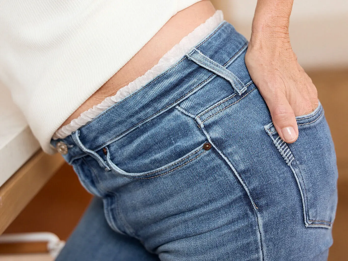 Woman wearing Svelte pull-up continence underwear beneath jeans